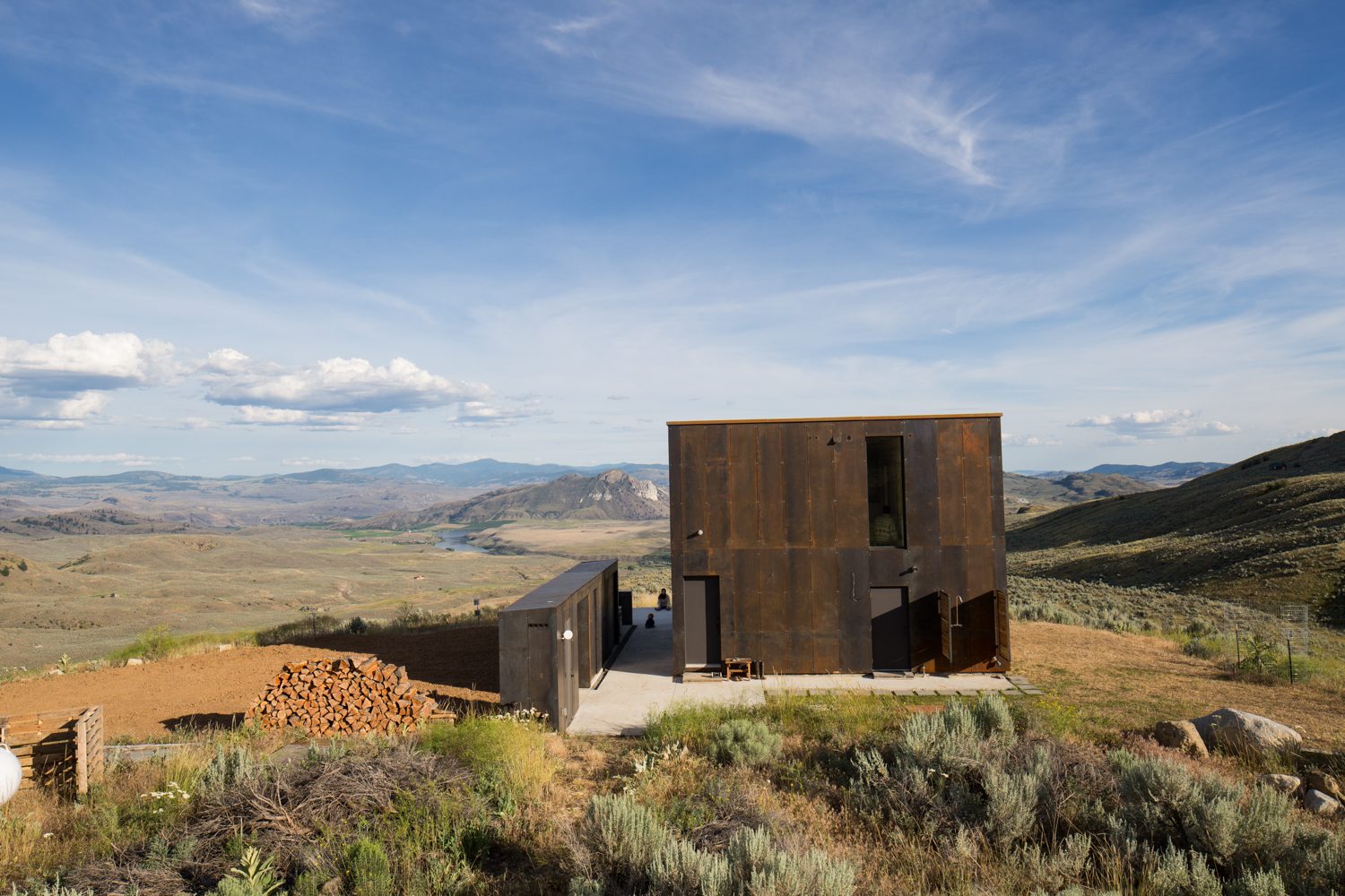 The house on its hilltop with the valley and mountains beyond